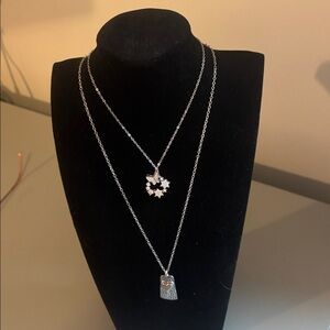 Two elegant silvertone necklaces with tags.
